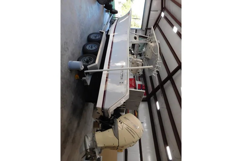 Slide: The Image of 2003 Regulator 32 Center Console boat in storage with triple-axle trailer. - 7