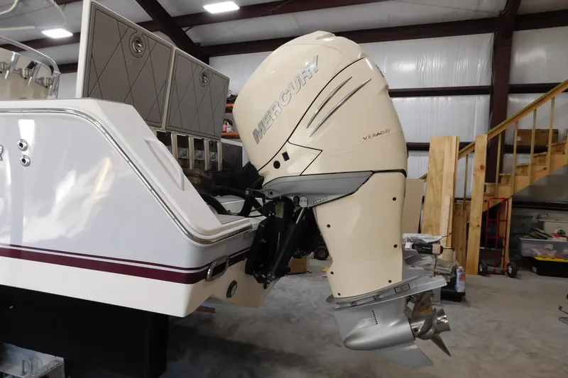 Slide: The Image of 2003 Regulator 32 Center Console with Mercury Verado outboard engine in a workshop setting. - 8