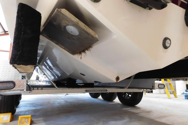 Slide: The Image of 2003 Regulator 32 Center Console boat on trailer, showing hull and undercarriage details. - 9