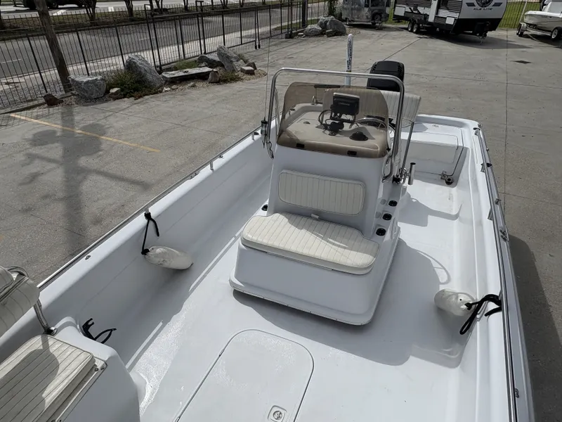 Slide: The Image of 2000 Fishmaster 23 boat with center console and seating, parked on concrete surface. - 10