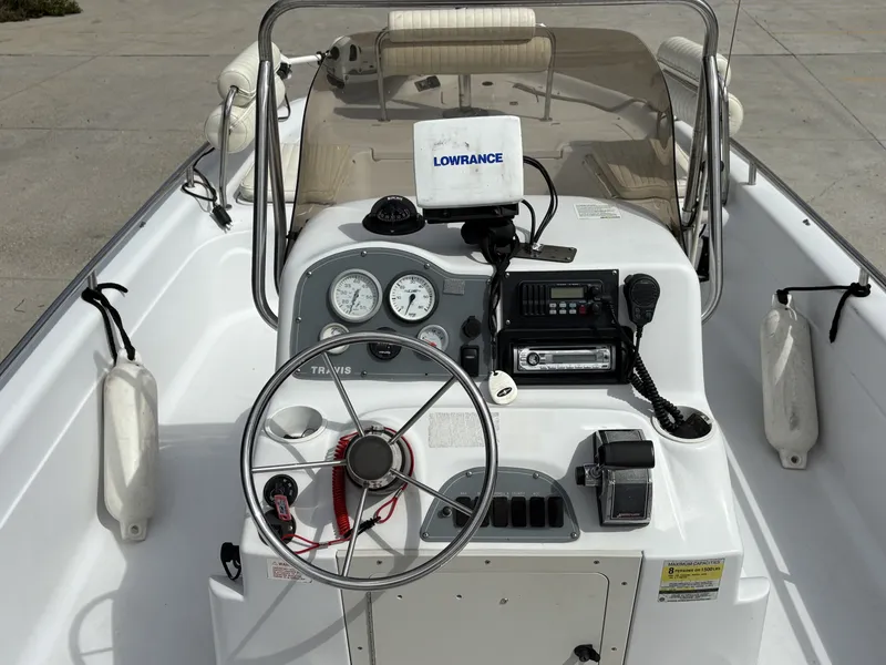 Slide: The Image of 2000 Fishmaster 23 boat dashboard with steering wheel, gauges, and navigation equipment. - 5