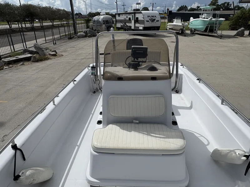 Slide: The Image of 2000 Fishmaster 23 boat with seating and console, parked near trailers and other boats. - 6