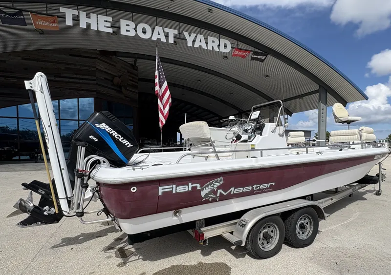 Slide: The Image of 2000 Fishmaster 23 boat on trailer at The Boat Yard, featuring Mercury engine. - 9