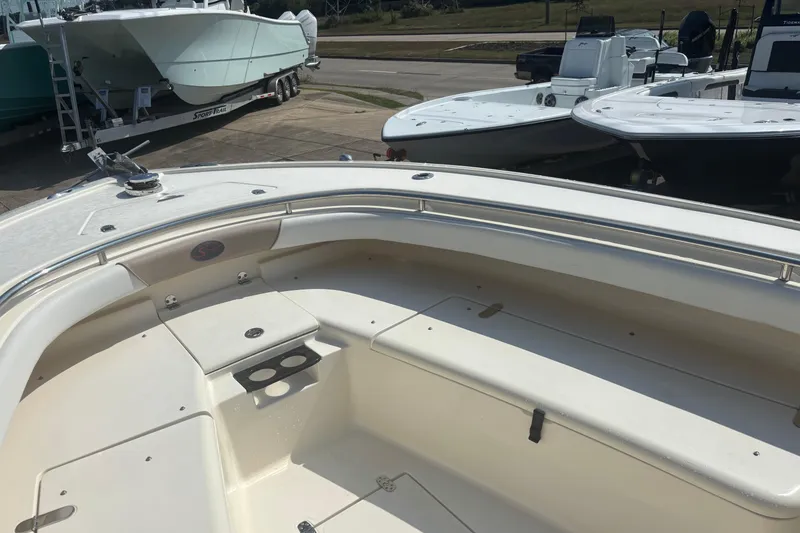 Slide: The Image of 2006 Scout 282 Sportfish boat interior with seating and cup holders, docked alongside other boats. - 10