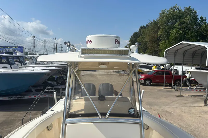 Slide: The Image of 2006 Scout 282 Sportfish boat at a dealership, surrounded by other boats and vehicles. - 11