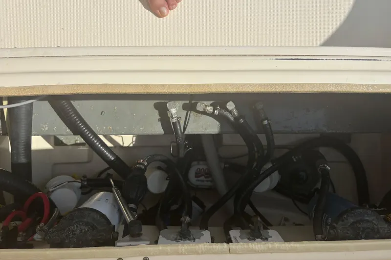 Slide: The Image of Engine compartment of a 2006 Scout 282 Sportfish boat, showing hoses and components. - 14