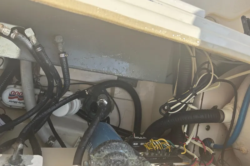 Slide: The Image of Engine compartment of a 2006 Scout 282 Sportfish boat showing hoses and wiring. - 16