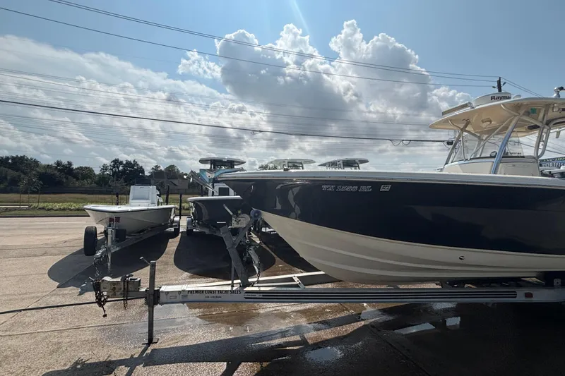 Slide: The Image of 2006 Scout 282 Sportfish boat on trailer under cloudy sky. - 25