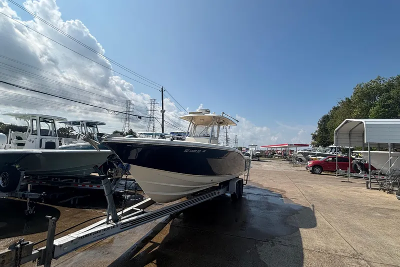 Slide: The Image of 2006 Scout 282 Sportfish boat on trailer under clear blue sky. - 26