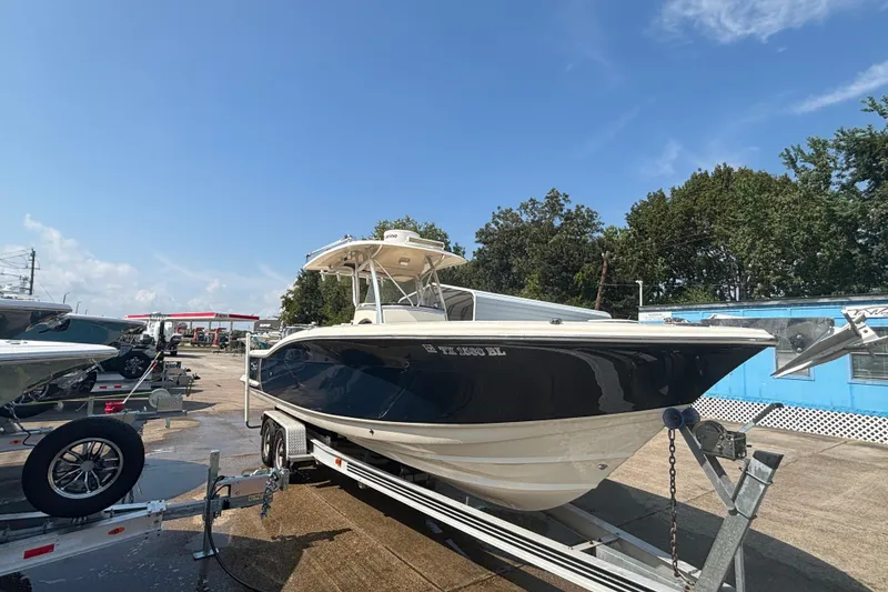 Slide: The Image of 2006 Scout 282 Sportfish boat on trailer under clear blue sky. - 27
