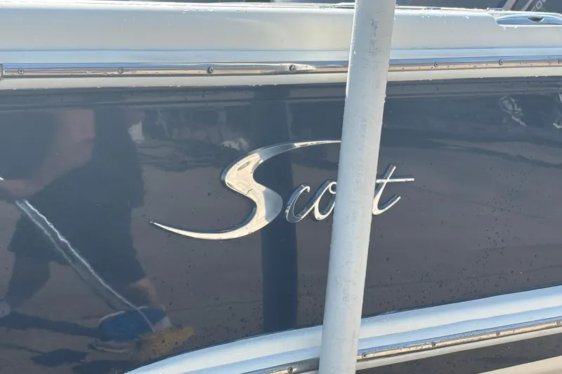 Slide: The Image of Scout 282 Sportfish 2006 boat with chrome logo on dark hull. - 34