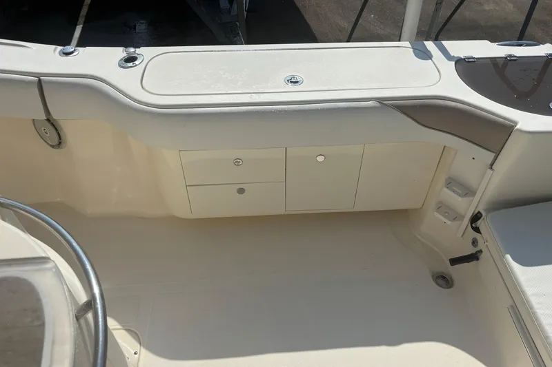 Slide: The Image of 2006 Scout 282 Sportfish boat interior with storage compartments and seating area. - 6