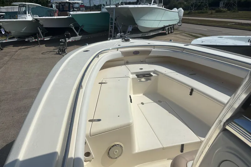 Slide: The Image of 2006 Scout 282 Sportfish boat interior with seating, docked alongside other boats. - 9