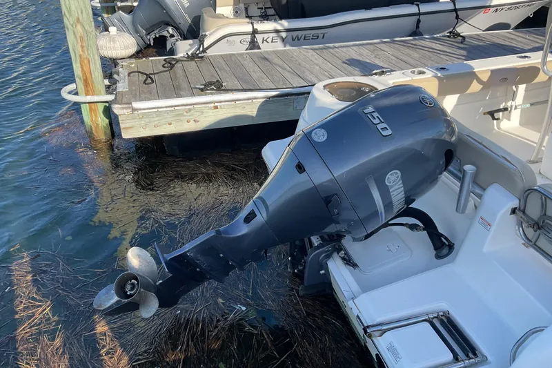 Slide: The Image of 2016 Sea Fox 226 Commander with Yamaha 150 outboard motor docked by pier. - 12