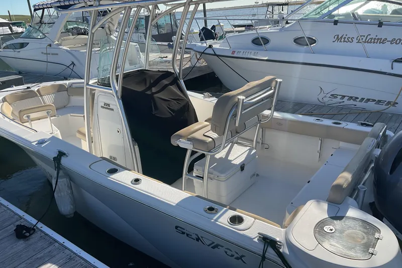 Slide: The Image of 2016 Sea Fox 226 Commander boat docked, featuring spacious seating and sleek design. - 7