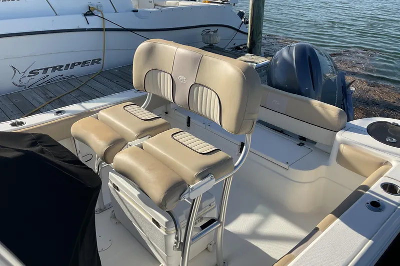 Slide: The Image of 2016 Sea Fox 226 Commander boat interior with beige seating and outboard motor. - 9