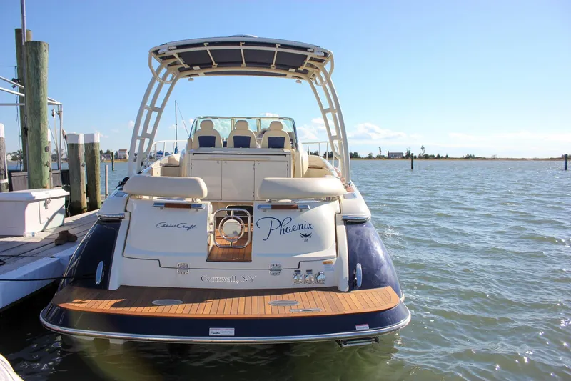The Image of 2017 Chris-Craft Launch 38 boat docked, rear view, sunny day, calm waters. - 0