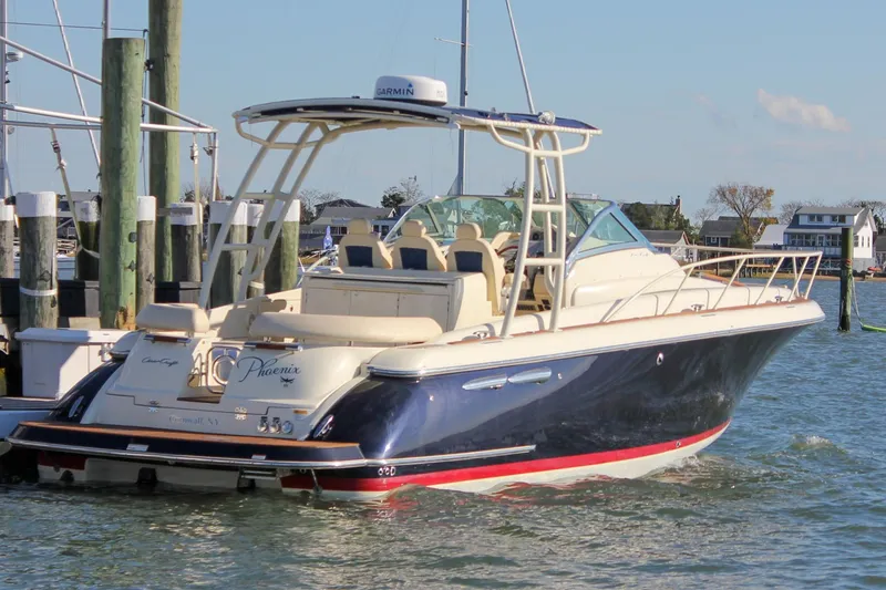 Slide: The Image of 2017 Chris-Craft Launch 38 boat docked in a marina, featuring elegant design and spacious seating. - 1