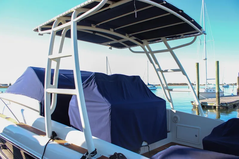 Slide: The Image of 2017 Chris-Craft Launch 38 boat with blue covers docked at a marina. - 102