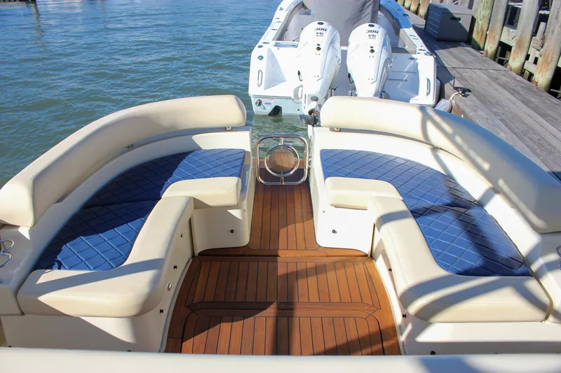 Slide: The Image of 2017 Chris-Craft Launch 38 boat with seating and canopy, docked by the water. - 15