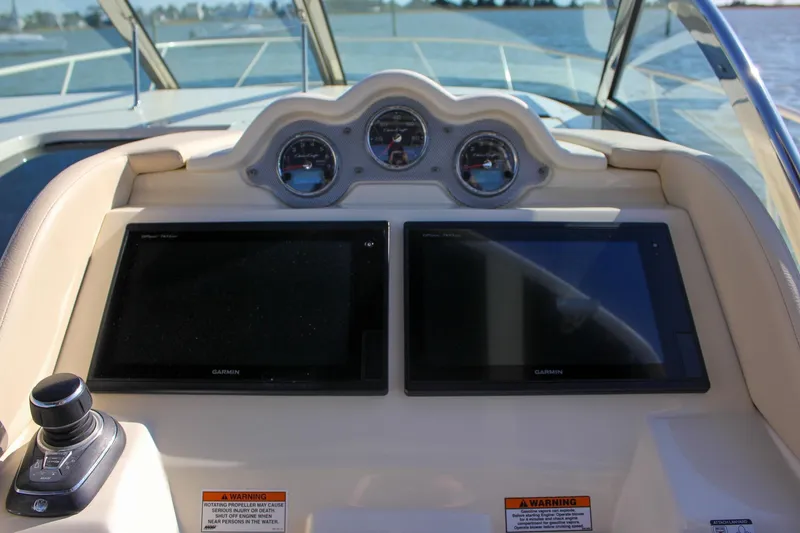 Slide: The Image of 2017 Chris-Craft Launch 38 helm with Garmin device, wooden steering wheel, and luxurious seating. - 33
