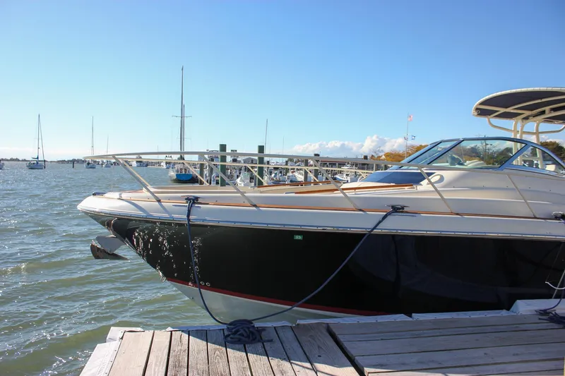 Slide: The Image of 2017 Chris-Craft Launch 38 boat docked in a marina, featuring elegant design and luxury seating. - 4