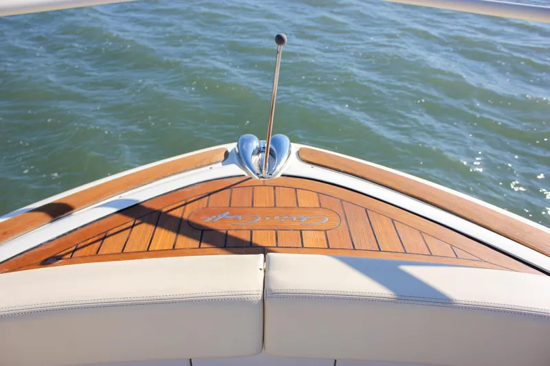 Slide: The Image of 2017 Chris-Craft Launch 38 boat docked, showcasing sleek design and wooden deck. - 45