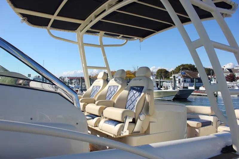 Slide: The Image of 2017 Chris-Craft Launch 38 boat docked at marina, covered with blue tarps. - 5