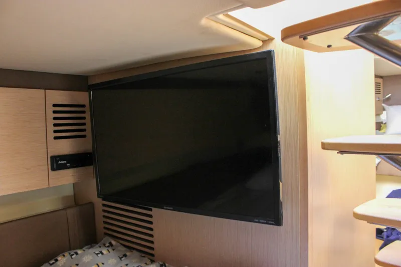 Slide: The Image of 2017 Chris-Craft Launch 38 interior shelving with wood paneling and metal rails. - 76