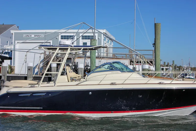 Slide: The Image of 2017 Chris-Craft Launch 38 interior with mounted flat-screen TV and wooden cabinetry. - 84
