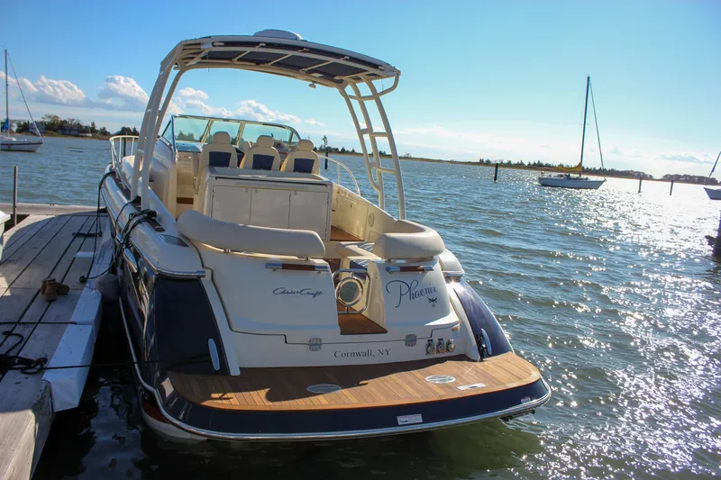 Slide: The Image of 2017 Chris-Craft Launch 38 boat docked, featuring elegant teak deck and luxurious seating. - 85