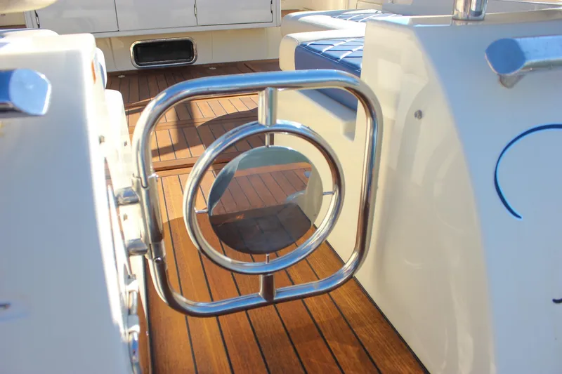 Slide: The Image of 2017 Chris-Craft Launch 38 boat docked in a marina, featuring elegant design and spacious seating. - 9