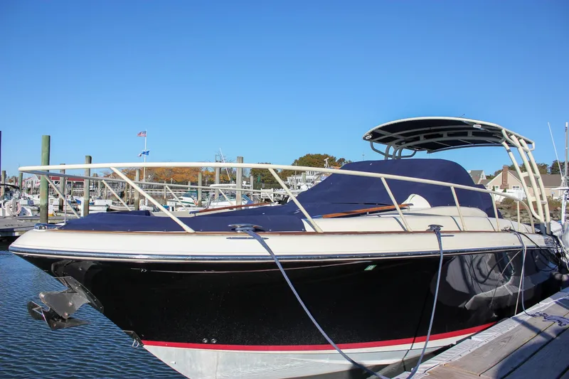 Slide: The Image of 2017 Chris-Craft Launch 38 docked at a marina under cloudy skies. - 92