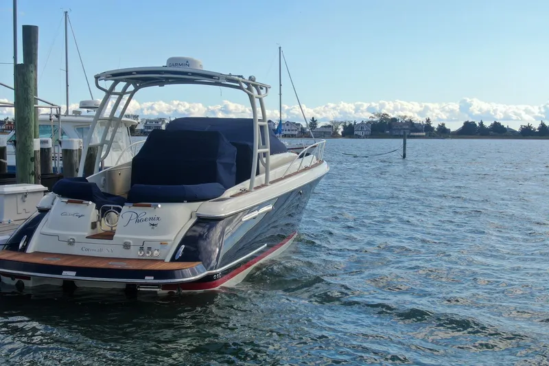 Slide: The Image of 2017 Chris-Craft Launch 38 boat docked on calm waters, clear sky background. - 98