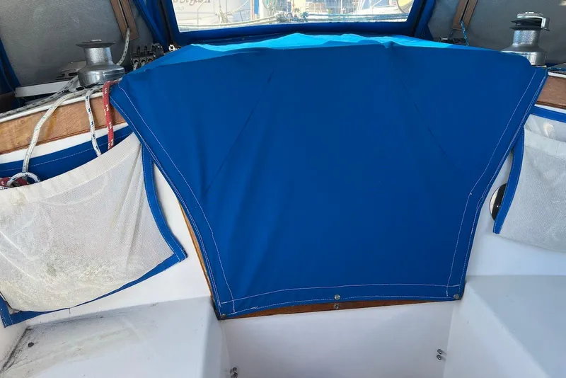 Slide: The Image of Cockpit of 1988 Catalina 34 mkI sailboat with blue cover and winches. - 13