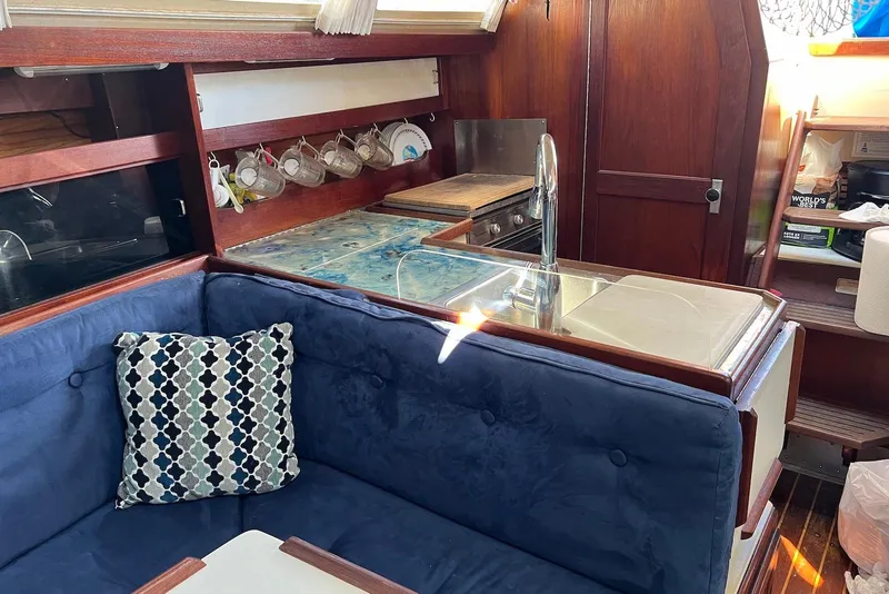 Slide: The Image of Interior of 1988 Catalina 34 mkI sailboat with cozy seating and kitchen area. - 15