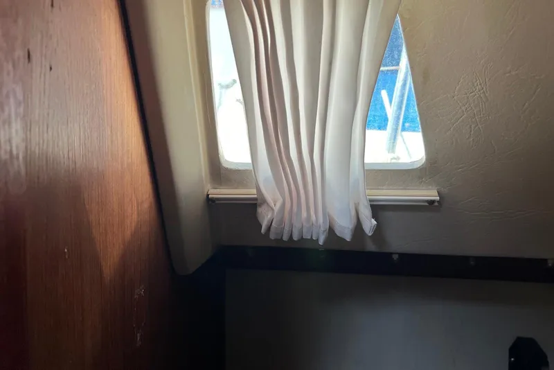 Slide: The Image of Interior of 1988 Catalina 34 mkI sailboat with window and curtain. - 19