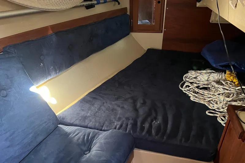 Slide: The Image of Interior cabin of a 1988 Catalina 34 mkI sailboat with blue cushions and coiled rope. - 20