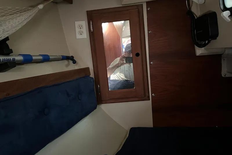 Slide: The Image of Interior of 1988 Catalina 34 mkI sailboat with mirror and blue cushions. - 22