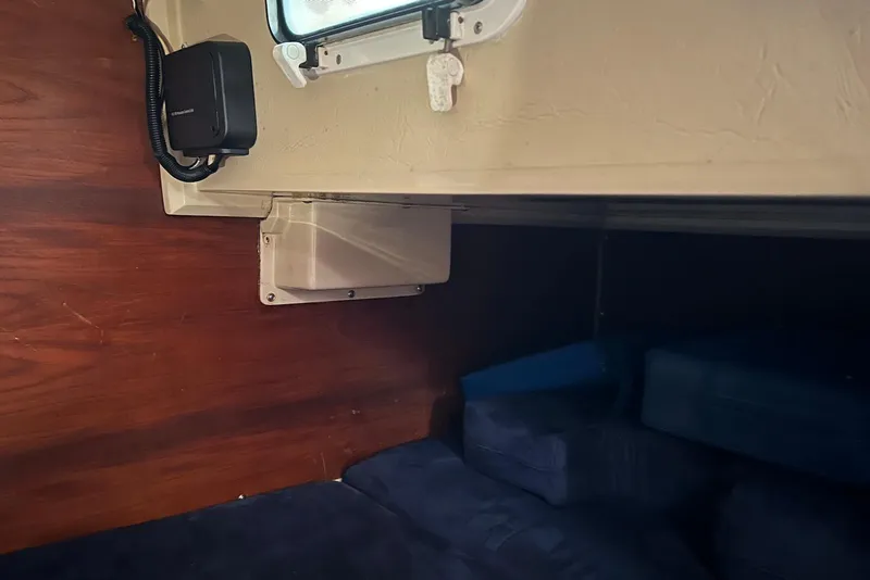Slide: The Image of Interior cabin of a 1988 Catalina 34 mkI sailboat with wood paneling and blue cushions. - 23