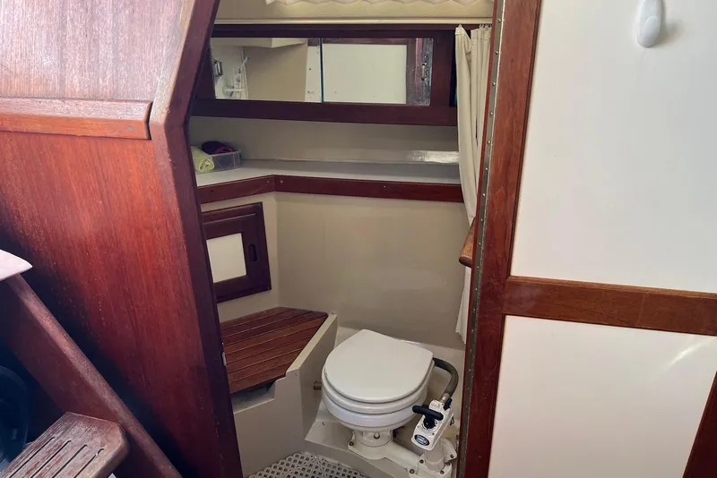 Slide: The Image of Interior of 1988 Catalina 34 mkI sailboat bathroom with wooden accents and marine toilet. - 26