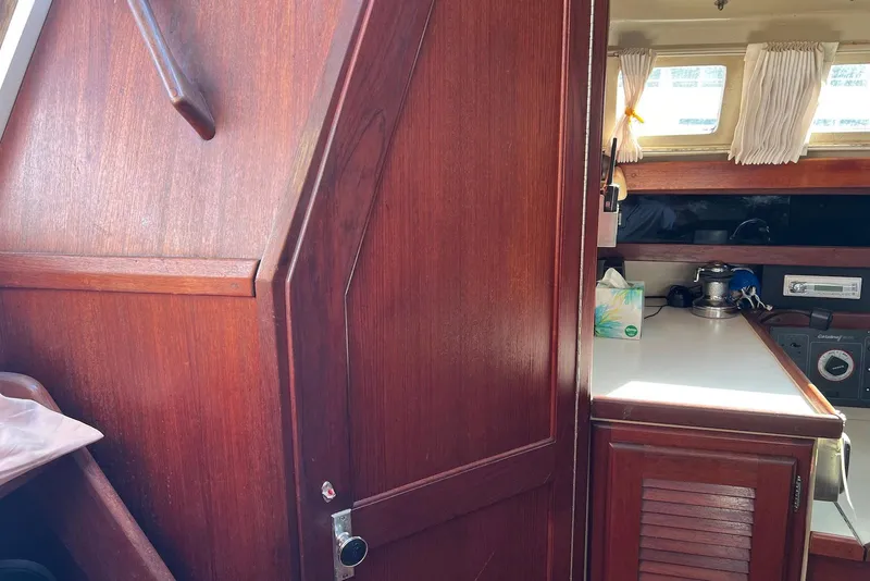 Slide: The Image of Interior of 1988 Catalina 34 mkI sailboat with wooden cabinetry and white countertop. - 27