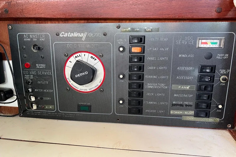 Slide: The Image of Electrical control panel of a 1988 Catalina 34 mkI sailboat with various switches and indicators. - 29