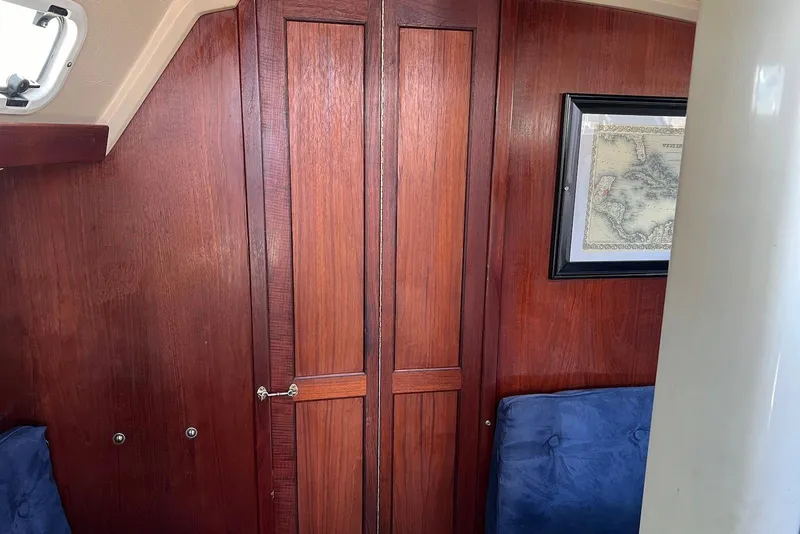 Slide: The Image of Interior of 1988 Catalina 34 mkI sailboat with wooden paneling and framed map. - 37