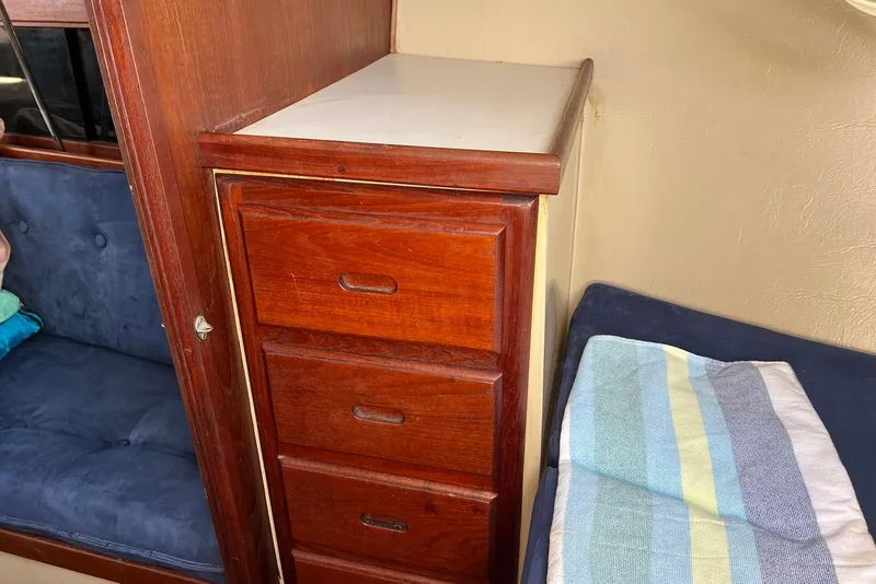 Slide: The Image of Wooden drawers and seating inside a 1988 Catalina 34 mkI sailboat cabin. - 38