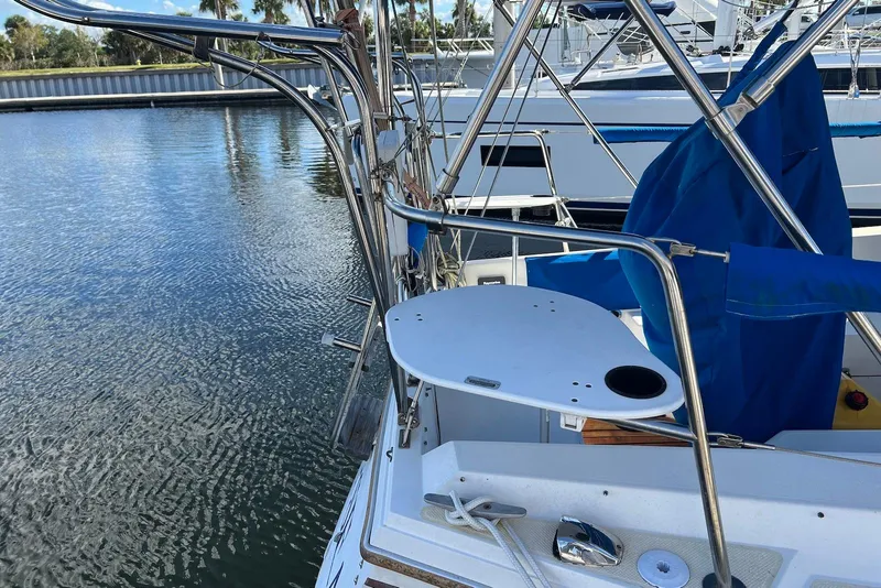 Slide: The Image of 1988 Catalina 34 mkI sailboat with stainless steel railings and marina backdrop. - 4