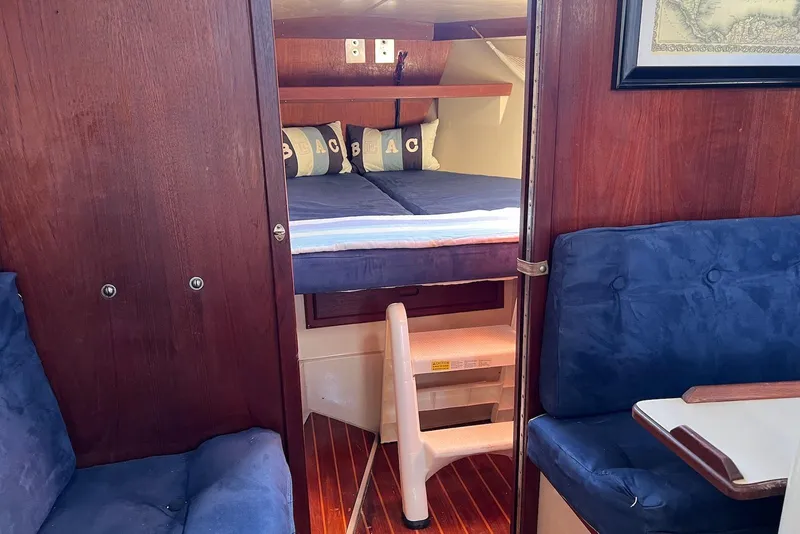 Slide: The Image of Interior of 1988 Catalina 34 mkI sailboat with cozy cabin and blue seating. - 40