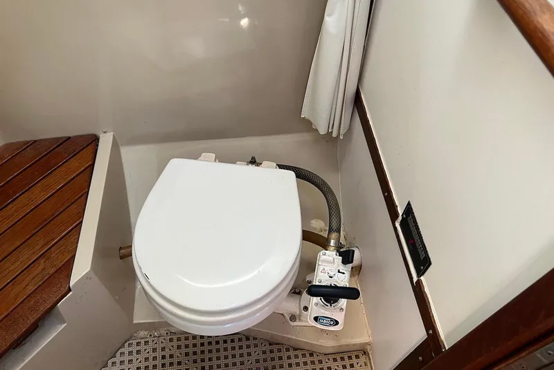 Slide: The Image of 1988 Catalina 34 mkI boat bathroom with marine toilet and wooden seat. - 43