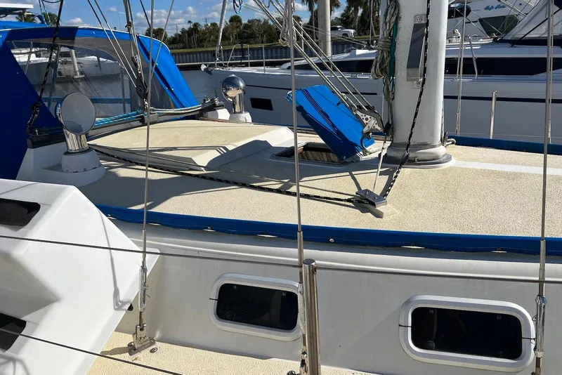 Slide: The Image of 1988 Catalina 34 mkI sailboat deck with rigging and hatch, docked in marina. - 5