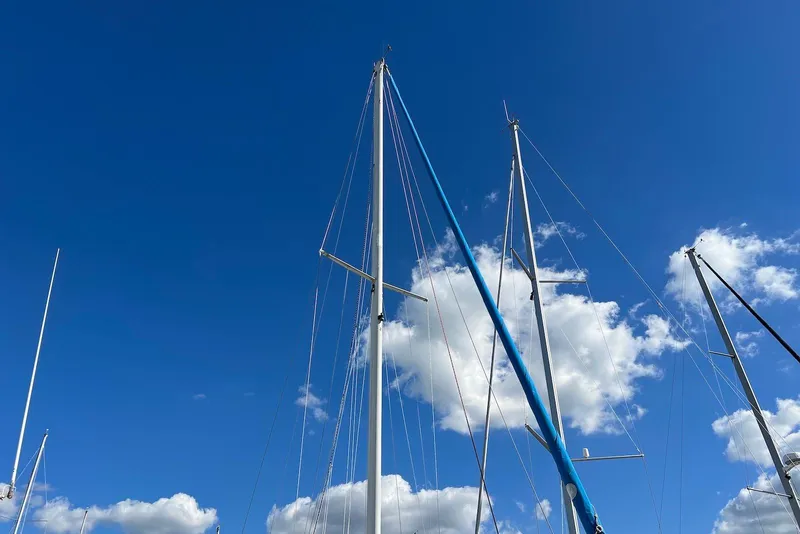 Slide: The Image of Tall masts of a 1988 Catalina 34 mkI sailboat against a clear blue sky. - 6